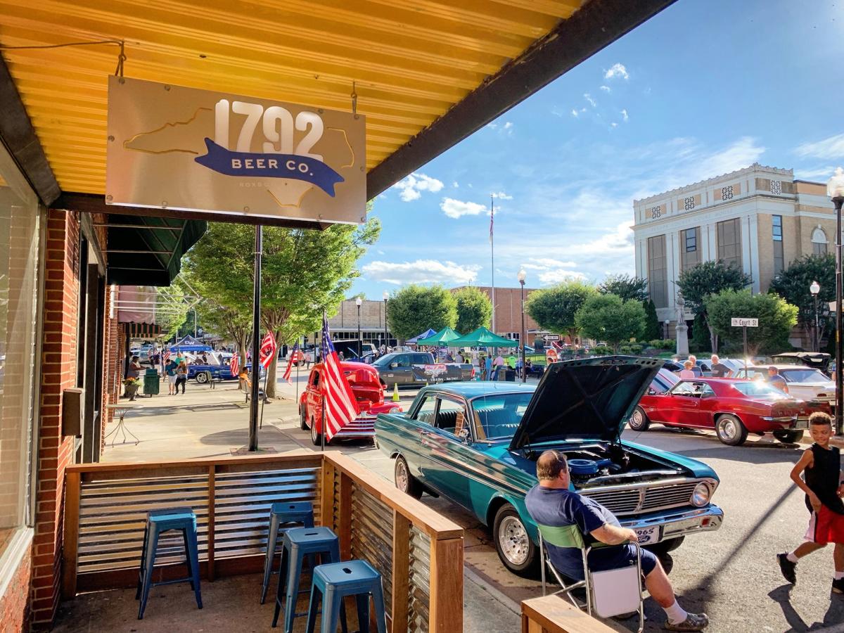 1792 Beer Co 1 Three women laugh at a restaurant table with glasses of beer