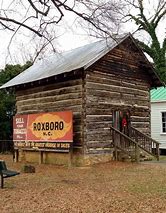 A small log building with steps on the right side