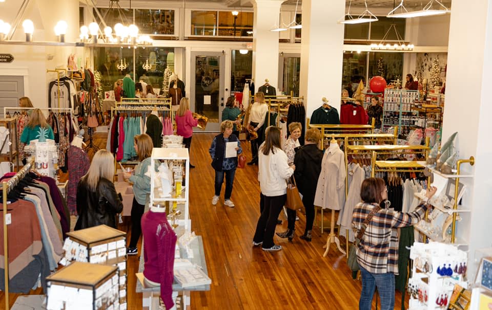 Specialty Design Company 3 Three women laugh at a restaurant table with glasses of beer