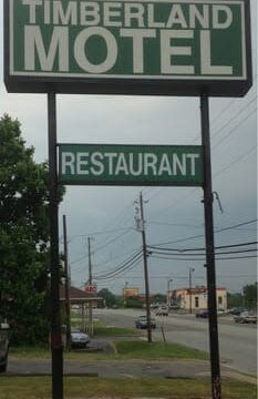 A tall sign for Timberland Motel and restaurant