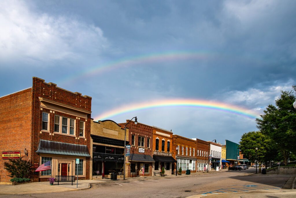 A double rainbow over red brick buildings