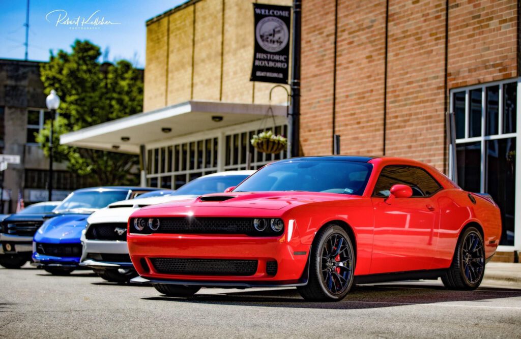Colorful sports cards parked in front of a red brick building