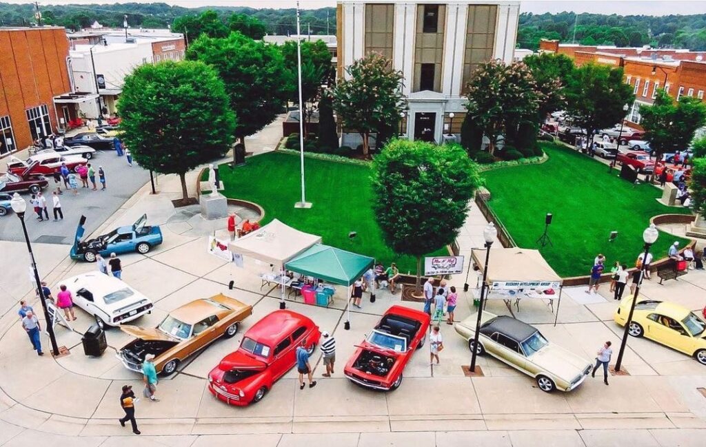 Classic cars parked in town for a car show event.