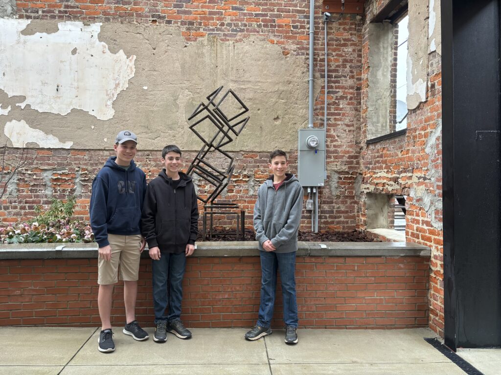 Metal Sculpture in Roxboro Savings Centennial park with artist Caleb, Carter, & Camden White
