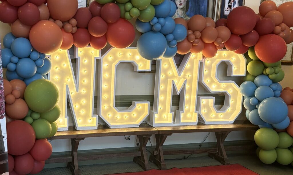 NC Main Street Conference sign with balloons